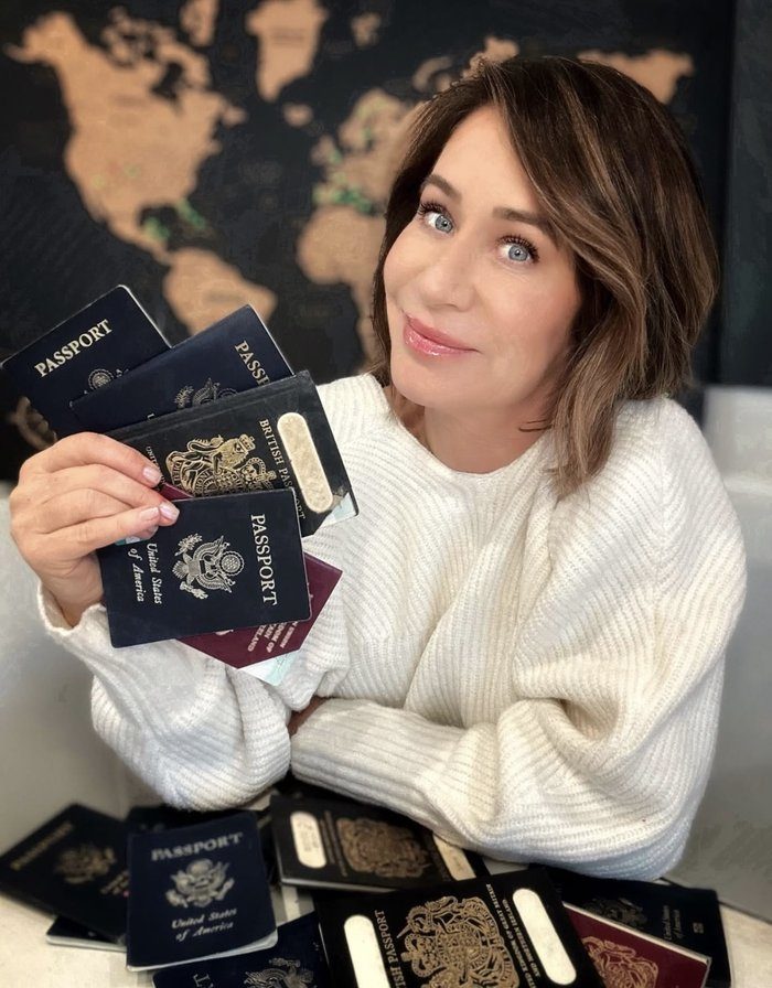 Heidi Finn holding three international passports