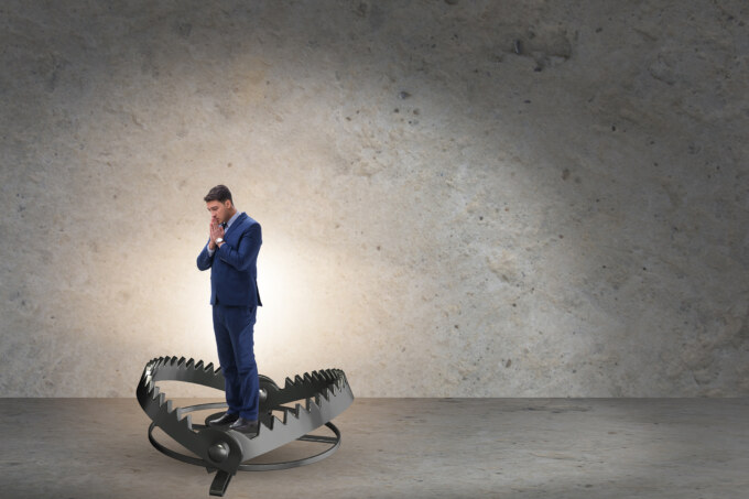 A man in a suit standing on top of a metal object.