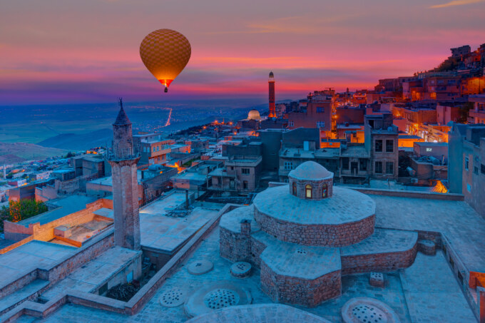 A hot air balloon flying over the city of turkey.