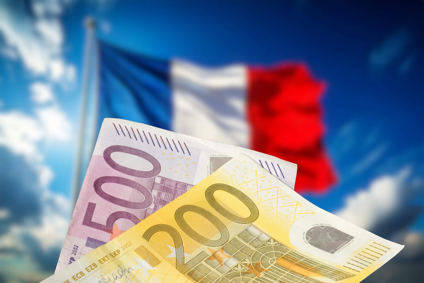 A close up of some euros in front of the french flag